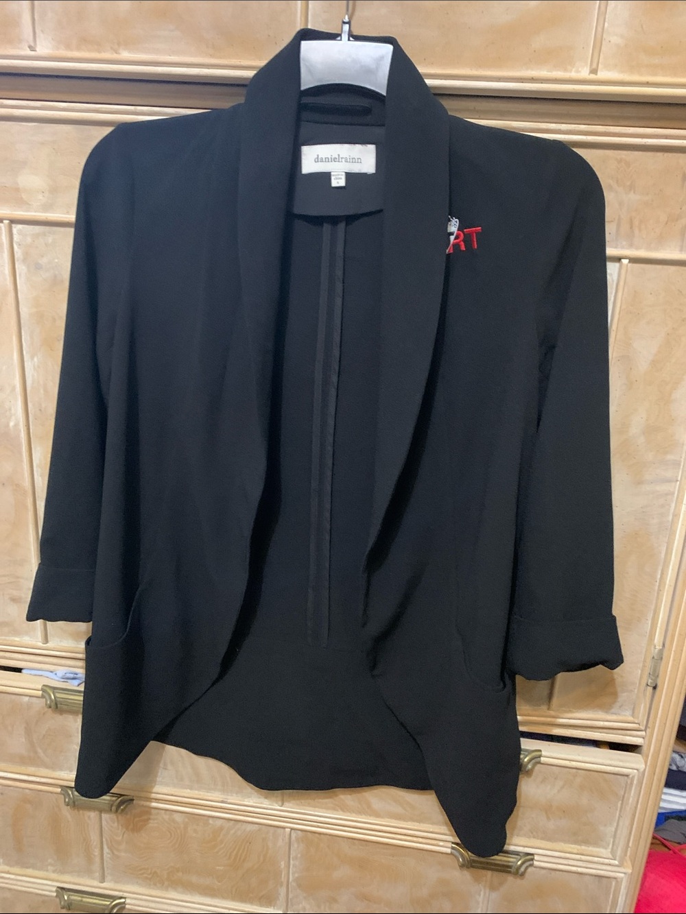 Black blazer with Art logo on left upper area.